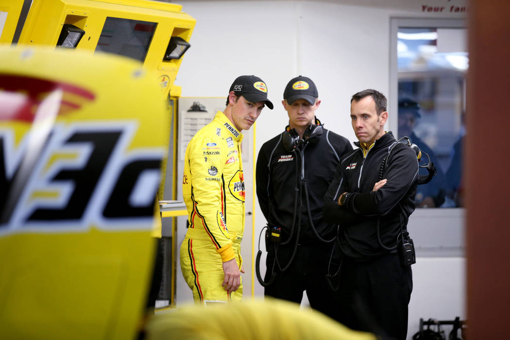 NASCAR Cup Series driver Joey Logano (22), left, talks to his crew after practice for SundayÕs ...