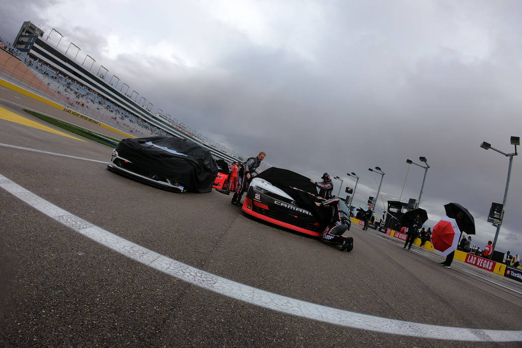 Cars are covered for rain during a rain delay before the start of NASCAR Xfinity Series Boyd Ga ...
