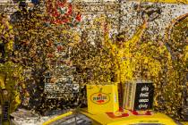 Joey Logano (22) is blasted with confetti as he celebrates in the winner's circle following the ...