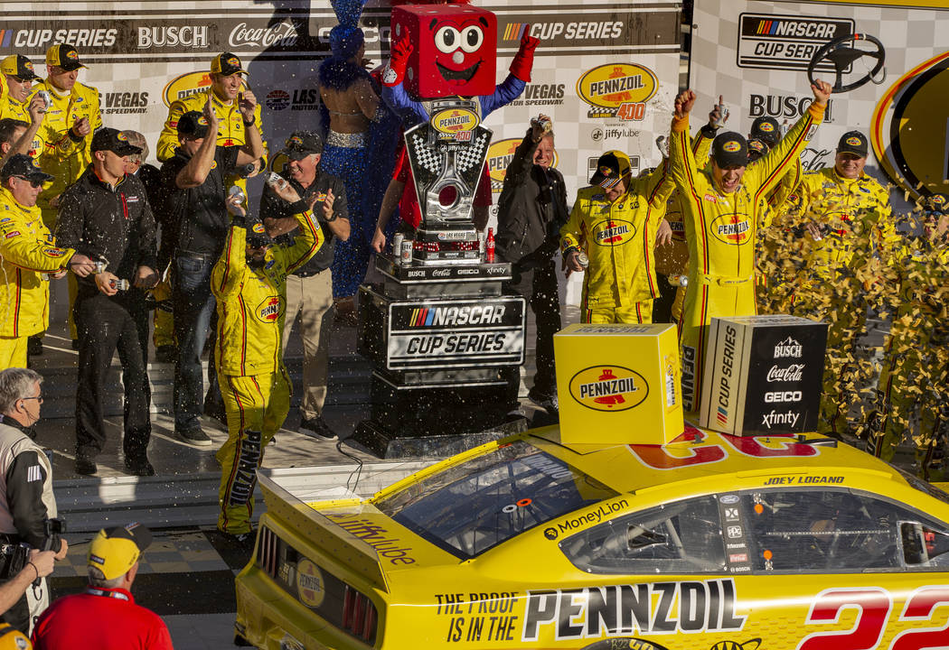 Joey Logano (22) and crew celebrate in the winner's circle following the Pennzoil 400 presented ...