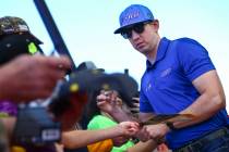 Kyle Busch gives autographs to fans before a NASCAR Cup Series auto race at the Las Vegas Motor ...