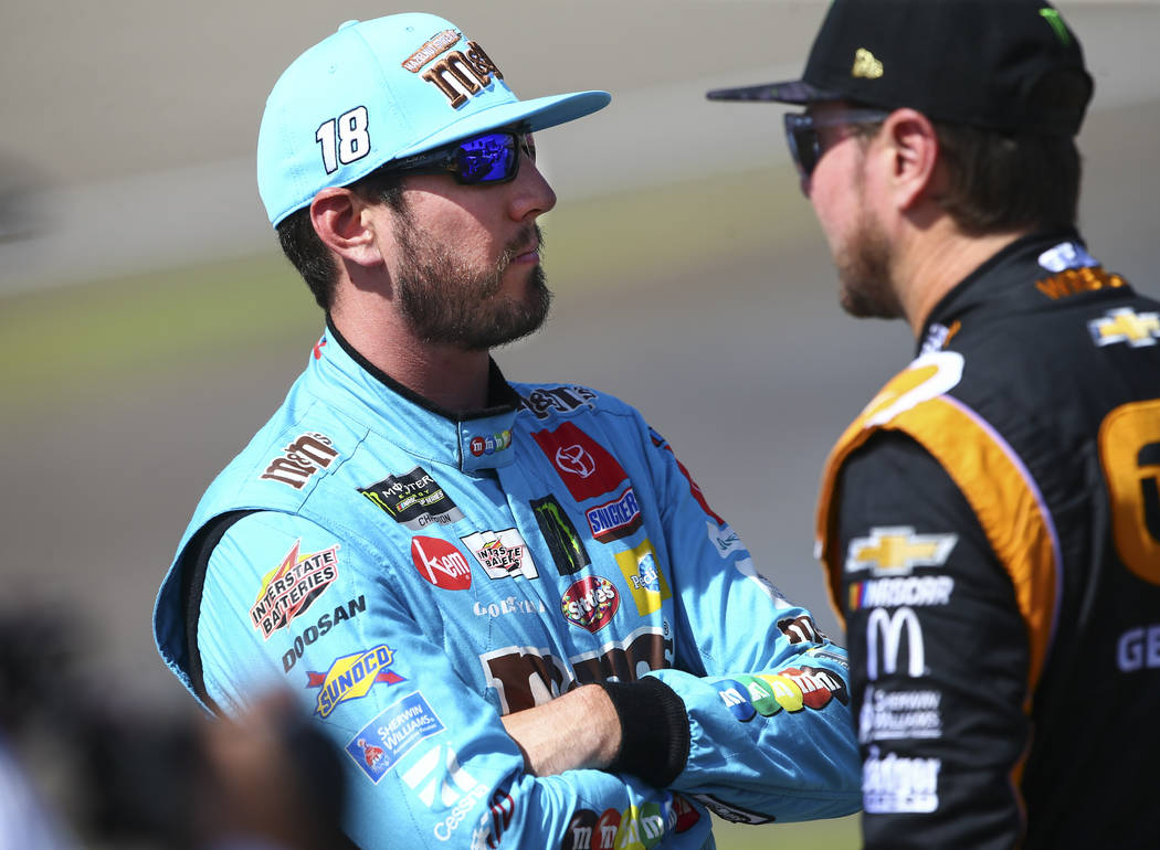 Kyle Busch, left, talks with Kurt Busch before qualifying for the Monster Energy NASCAR Cup Ser ...