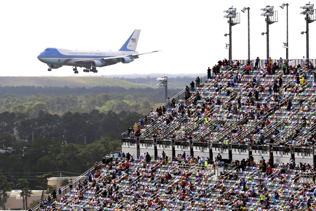 Race fans watch from the grandstands as Air Force One circles the Daytona International Speedwa ...