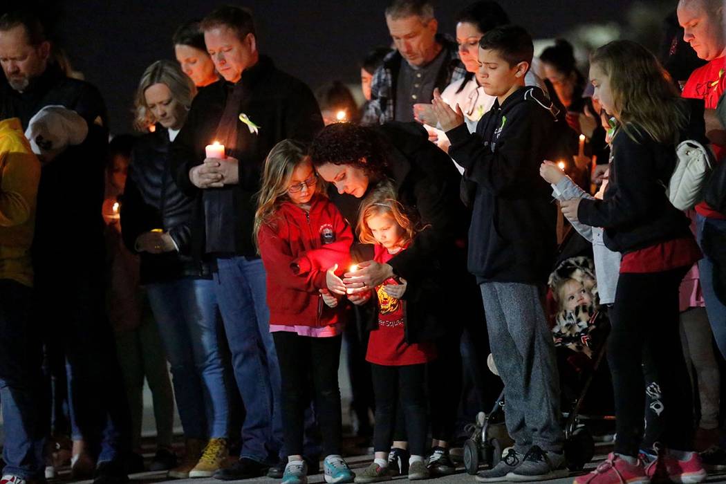 Dozens of parents and students hold candles during a candlelight vigil at Somerset Academy in N ...