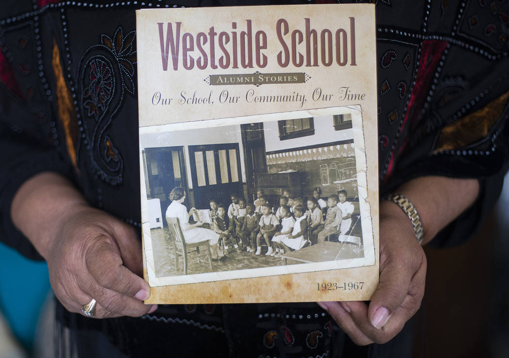 Brenda J. Williams, author of "Westside School: Our School Our Time," holds the book at her hom ...