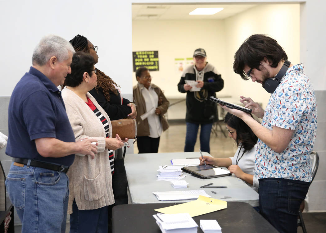 Nation Graca, right, site leader, and Alyssa Cortez, a volunteer, register voters during the la ...