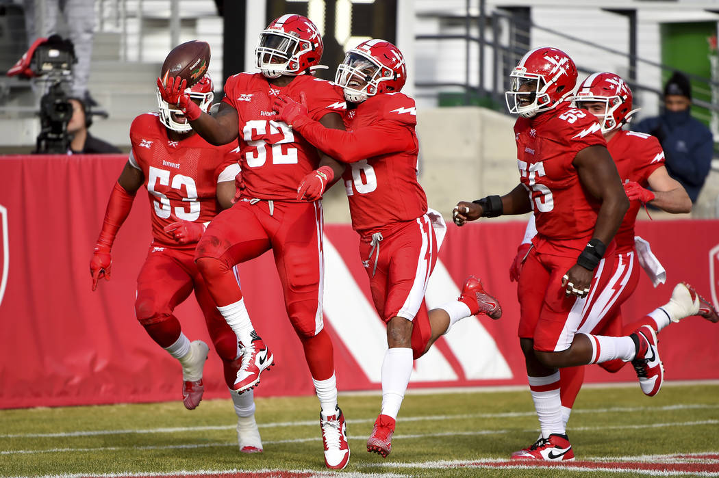 DC Defenders linebacker Jonathan Celestin (52) celebrates with teammates after scoring a touchd ...