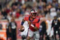 Houston Roughnecks quarterback P.J. Walker (11) looks to pass as he scrambles during an XFL foo ...