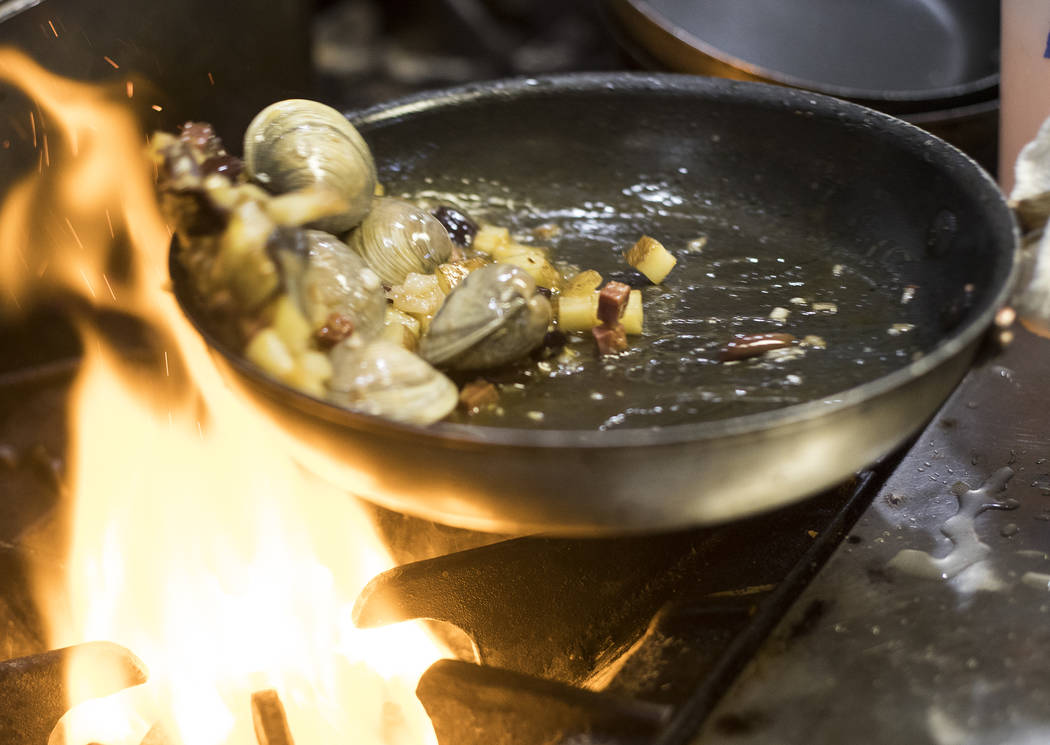 Chef Jennifer Landry prepares the base for the clam bake at the restaurant and bar 18bin in the ...