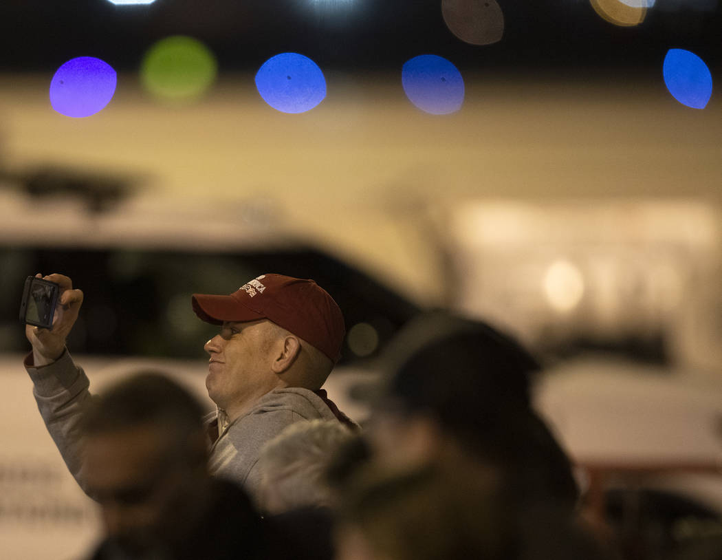 A Trump supporter photographs himself in front of Air Force One after President Donald Trump ar ...