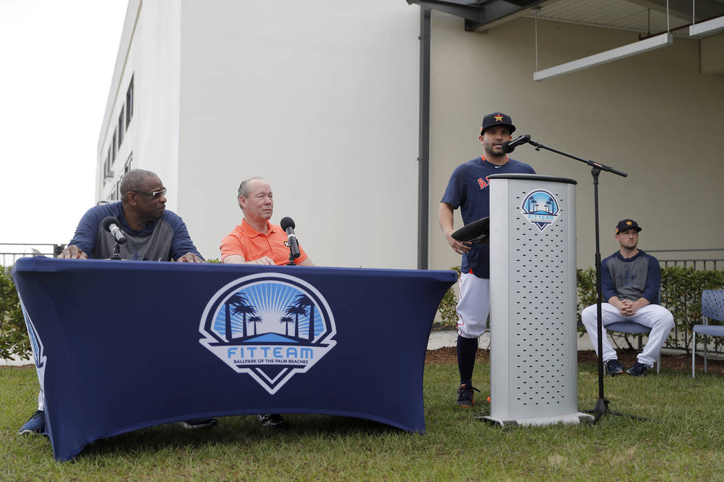 Houston Astros' Jose Altuve, delivers a statement from the podium as teammate Alex Bregman, rig ...