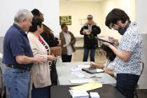 Nation Graca, right, site leader, and Alyssa Cortez, a volunteer, register voters during the la ...
