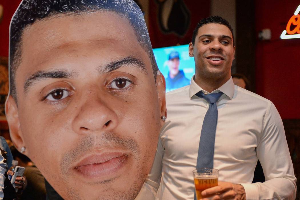 Vegas Golden Knights player Ryan Reaves holds up a cutout of himself at a party for the release ...