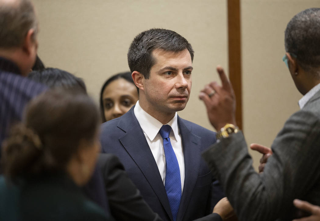 Democratic presidential candidate former South Bend Mayor Pete Buttigieg, middle, speaks with s ...