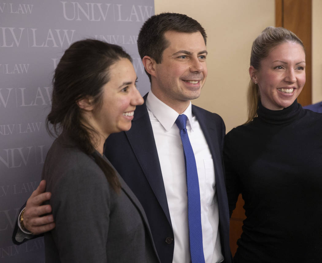 Democratic presidential candidate former South Bend Mayor Pete Buttigieg, middle, takes photos ...