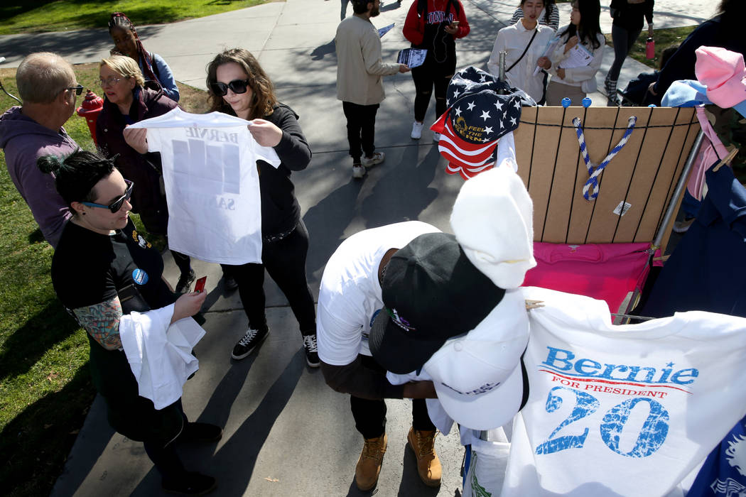 Taylor Rosenstein, 26, left, and Janet Lloyd, 32, both of Las Vegas, buy T-shirts from a vendor ...