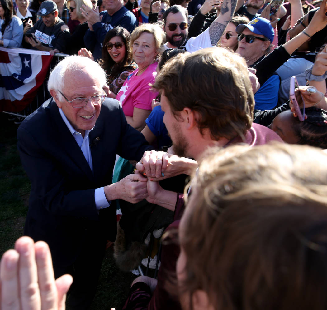 Vermont Sen. Bernie Sanders shakes hands with Brian Maxwell, 26, of Fort Collins, Colo. during ...
