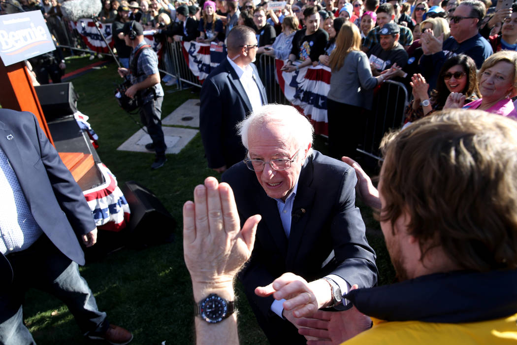 Vermont Sen. Bernie Sanders shakes hands with Brady Maxwell, 26, of Fort Collins, Colo. during ...