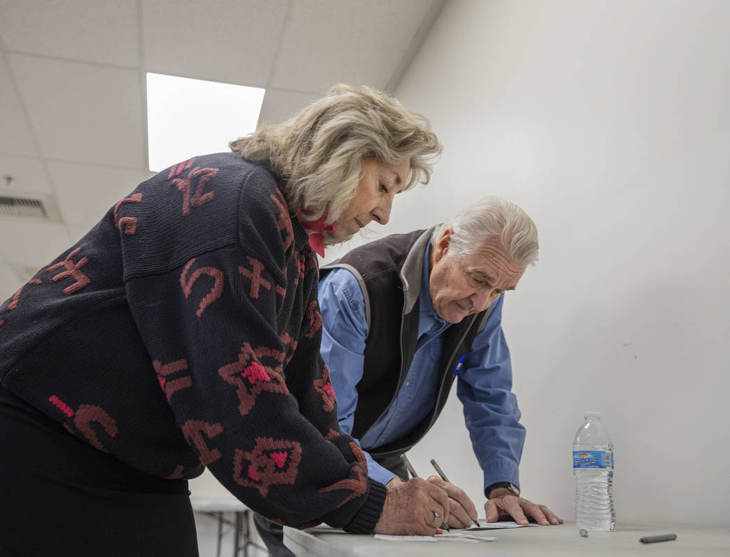 Rep. Dina Titus, D-Nev., left, and husband Thomas Wright cast their early vote at Cardenas Mark ...