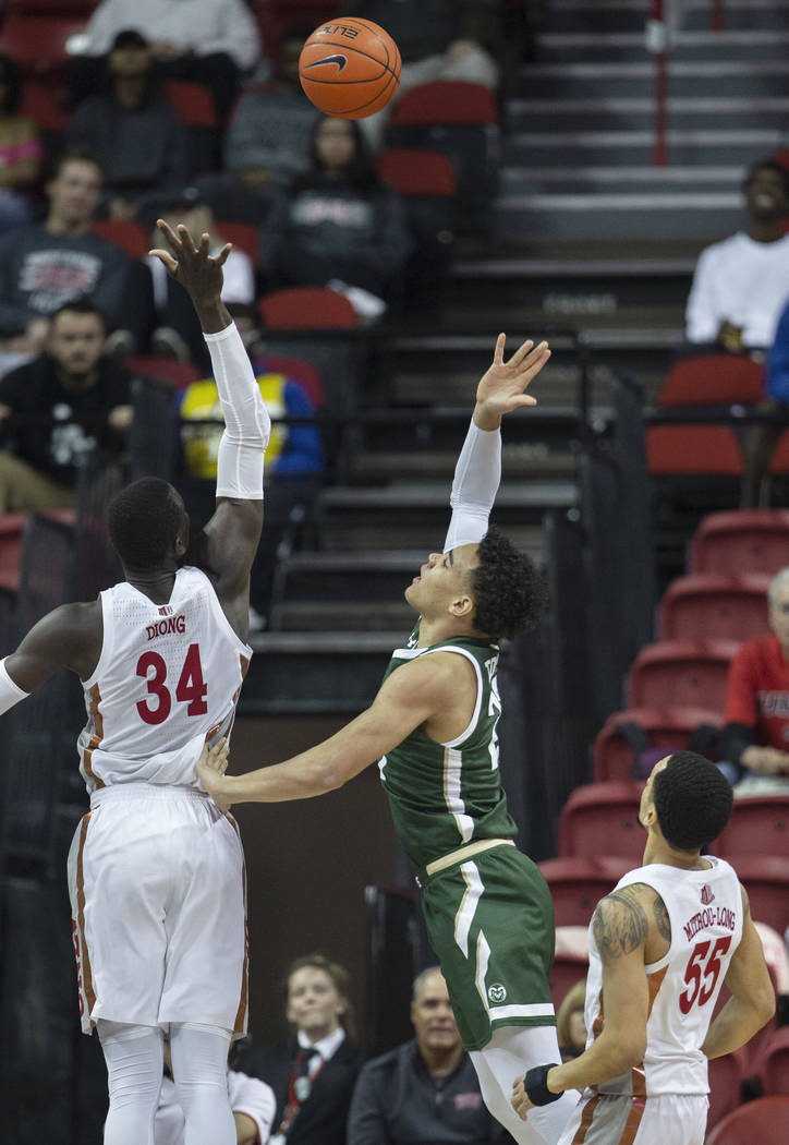 UNLV Rebels forward Cheikh Mbacke Diong (34) reaches to block the shot of Colorado State Rams g ...