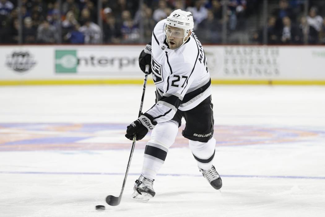 Los Angeles Kings' Alec Martinez shoots during the first period of the team's NHL hockey game a ...