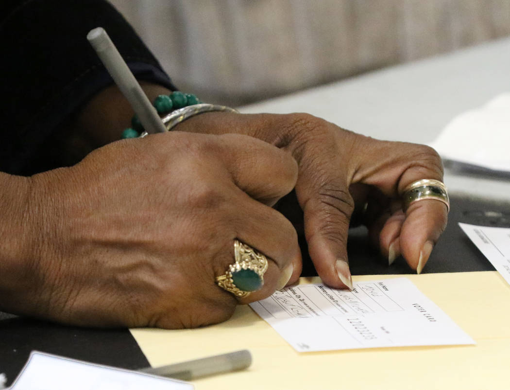 Joyce Williams-Mitchell fills out her voting card during the last day of early voting in the Ne ...