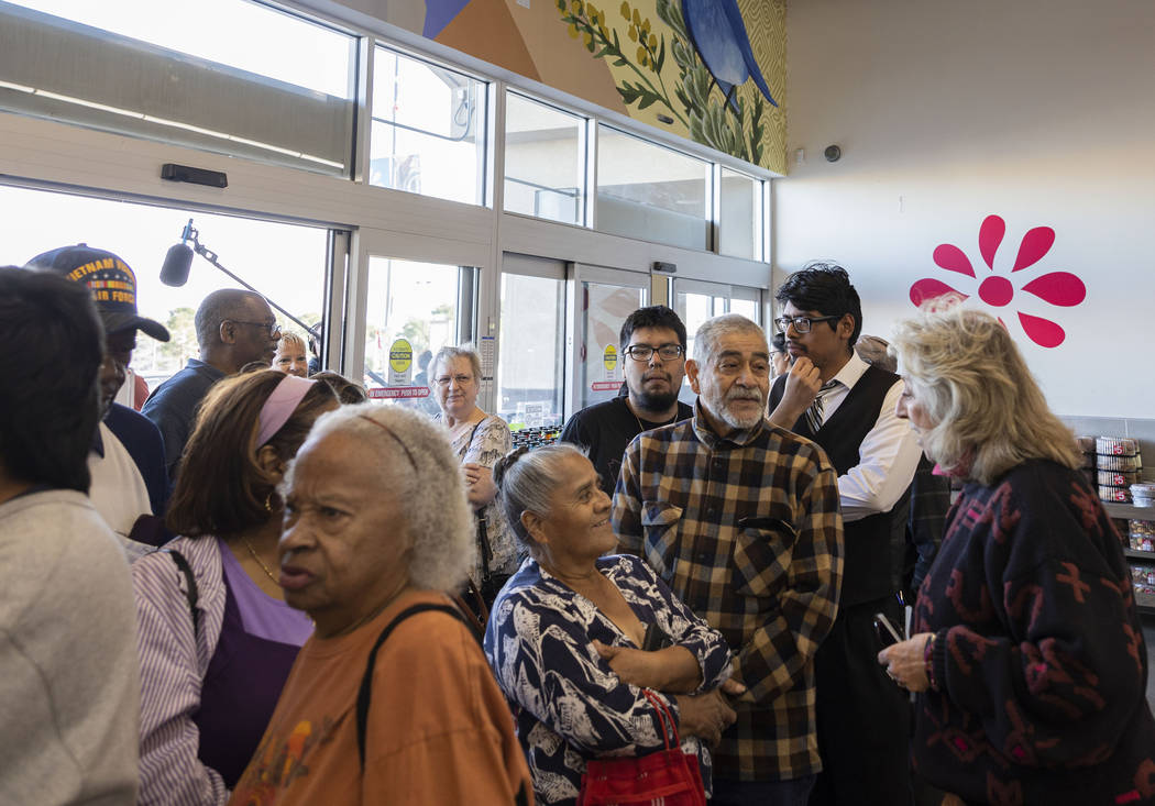 Rep. Dina Titus, D-Nev., greets people as they wait in line to cast their early vote at Cardena ...