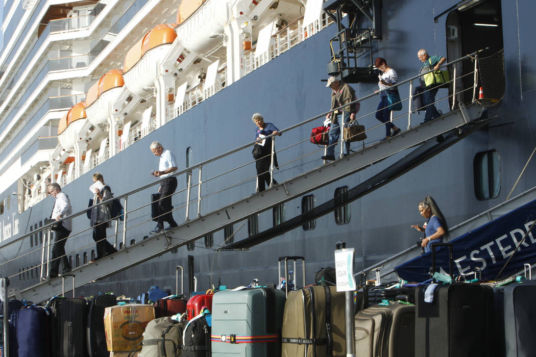 Passengers of the MS Westerdam, back, owned by Holland America Line, disembark at the port of S ...