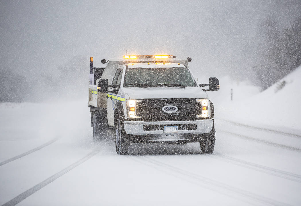 A Nevada Department of Transportation vehicle drives in heavy snow at Mount Charleston on Wedne ...