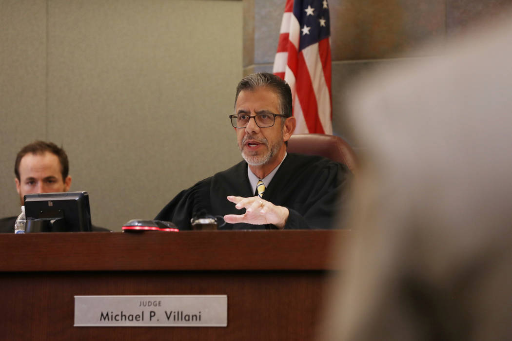 District Judge Michael Villani speaks with Chief Deputy Special Public Defender Clark Patrick d ...