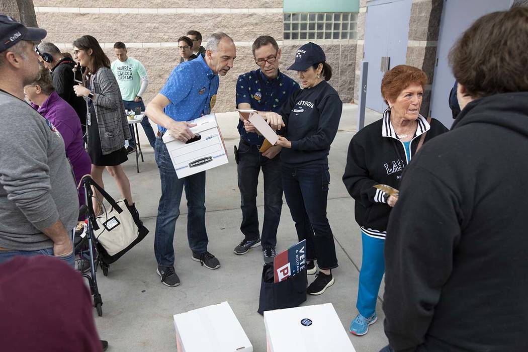Pete Buttigieg supporters converse before the Nevada caucus begins at Palo Verde High School on ...