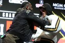 Deontay Wilder, left, shoves Tyson Fury during a press conference at the MGM Grand Garden Arena ...
