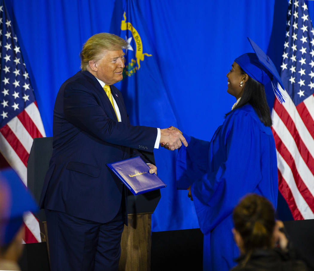 President Donald Trump hands out diplomas during a graduation ceremony for participants of the ...