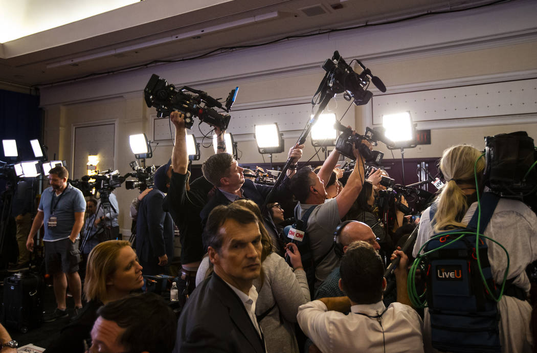 Members of the media clamor around candidates in the spin room after the Democratic presidentia ...