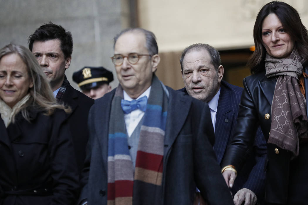 Harvey Weinstein, second right, leaves a Manhattan courthouse during his rape trial, Wednesday, ...