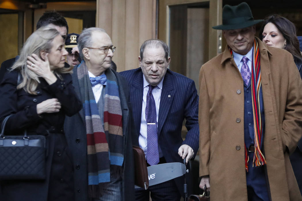 Harvey Weinstein, center, leaves a Manhattan courthouse during his rape trial, Wednesday, Feb. ...
