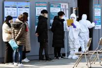 People suspected of being infected with the new coronavirus wait to receive tests at a medical ...