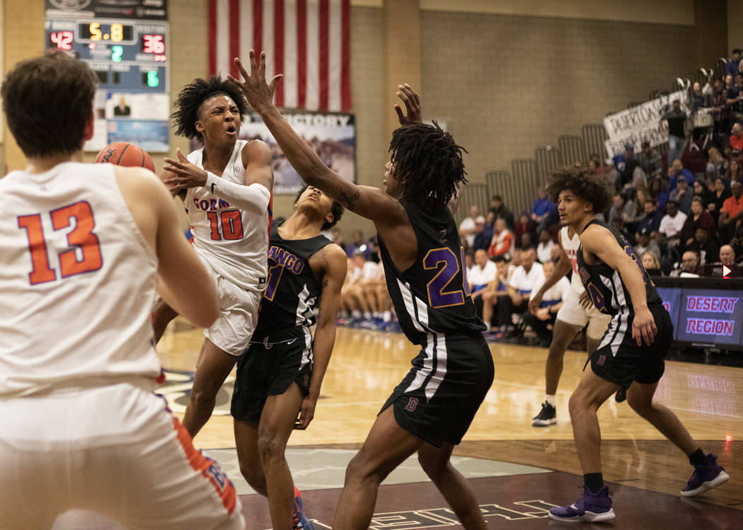 Bishop Gorman's Zaon Collins (10) jumps up for a shot as Durango's Kendrick Gilbert (24) reache ...