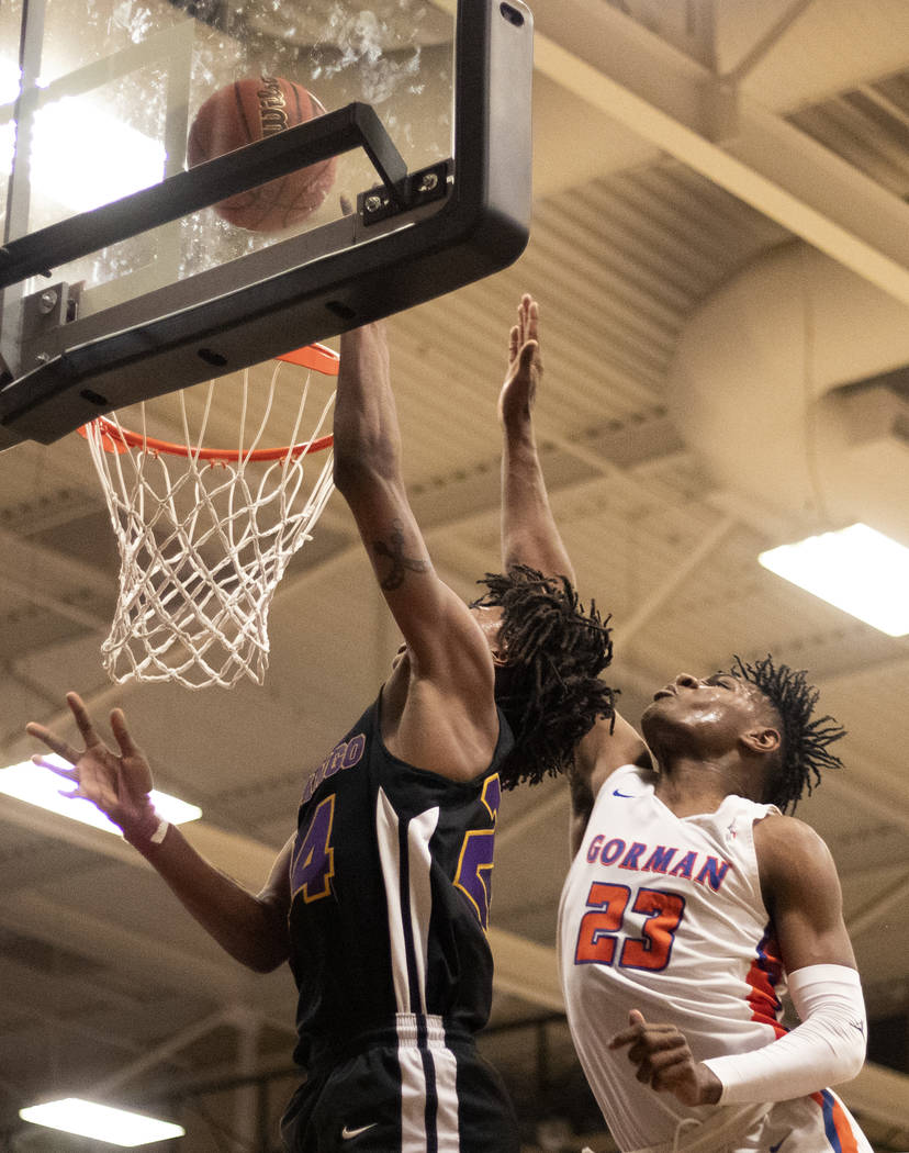 Bishop Gorman's Mwani Wilkinson (23) reaches to block a point by Durango's Kendrick Gilbert (24 ...