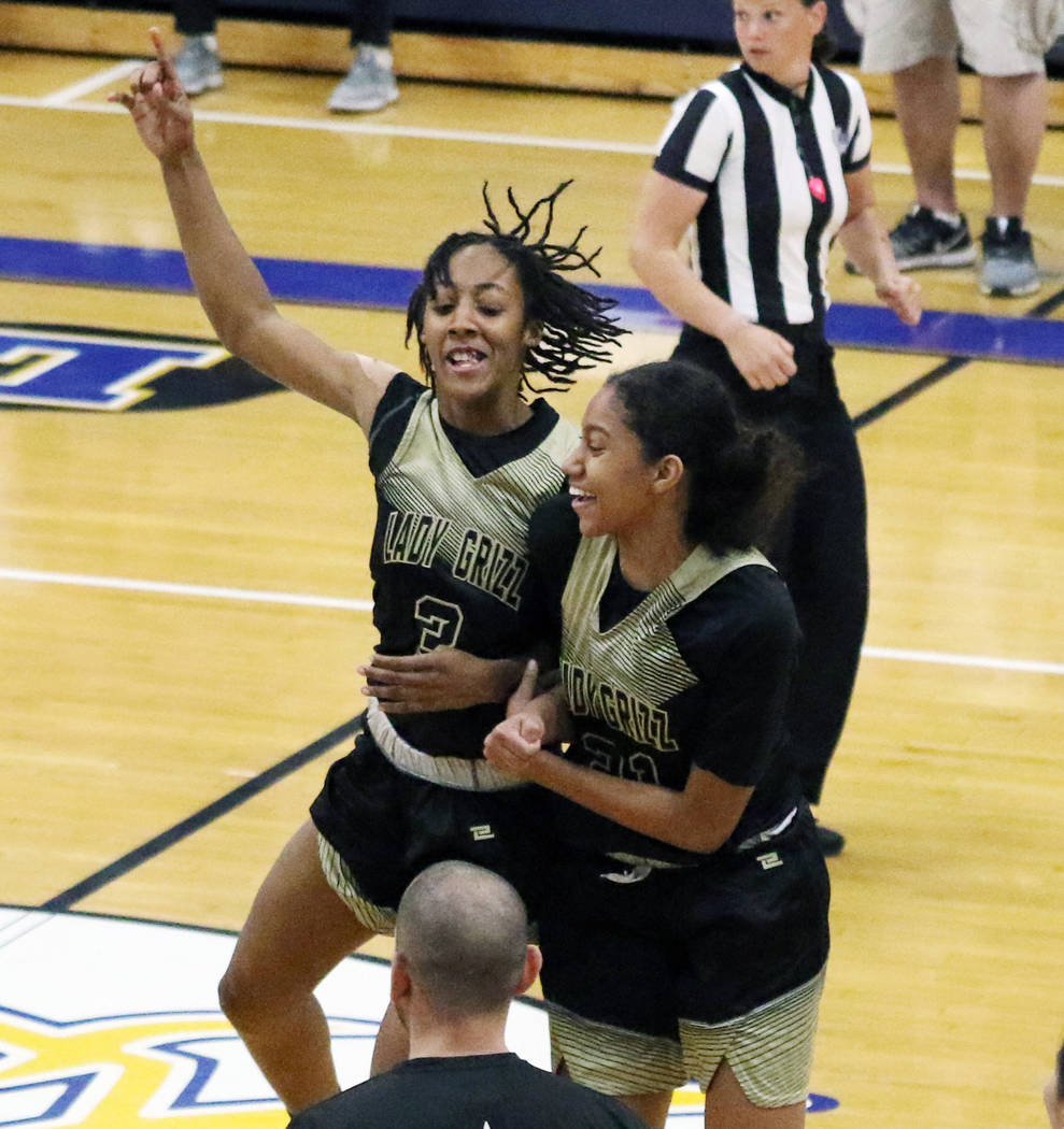 Spring Valley's Aaliyah Gayles (3) and Kylah Collins (21) celebrate after winning their first-r ...