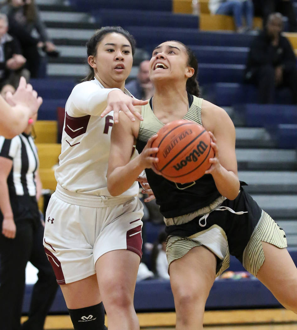 Faith Lutheran's Jalen Tanuvasa, left, defends Spring Valley's Kiana Turenne during the second ...