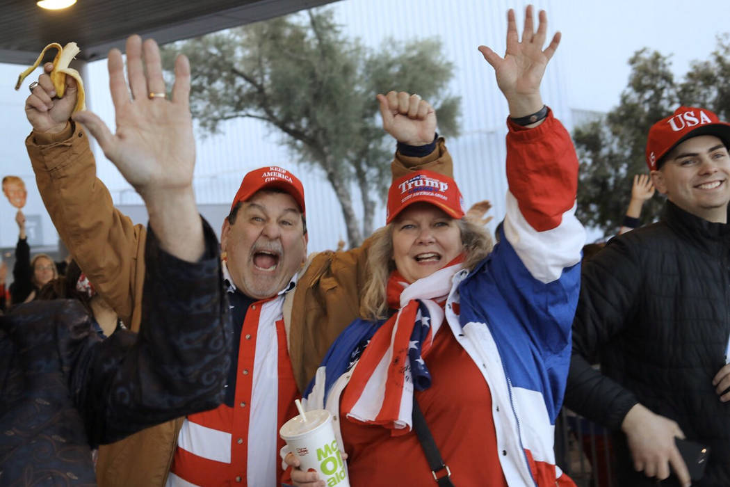 Don and Denise DeRosa, of El Dorado, Calif., cheer for President Trump before a campaign rally ...