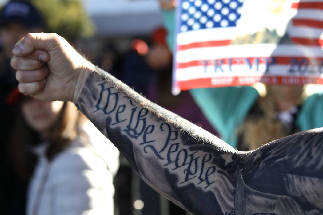 Doug Durbin of Las Vegas shows off his tattoo before a President Trump campaign rally Friday, F ...