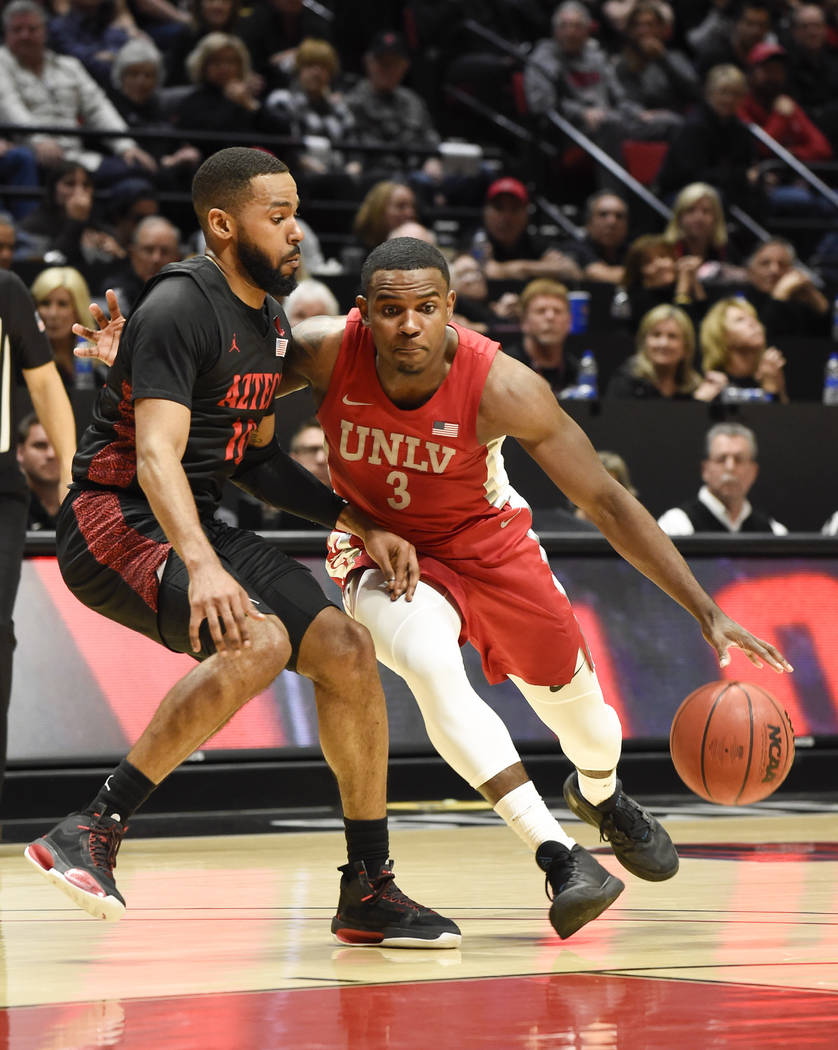 UNLV guard Amauri Hardy (3) drives past San Diego State guard KJ Feagin (10) during the first h ...