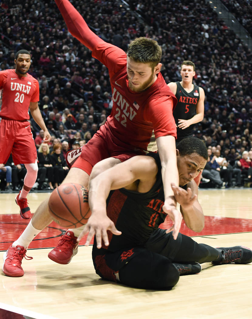 San Diego State forward Matt Mitchell (11) fights for the ball with UNLV forward Vitaliy Shibel ...