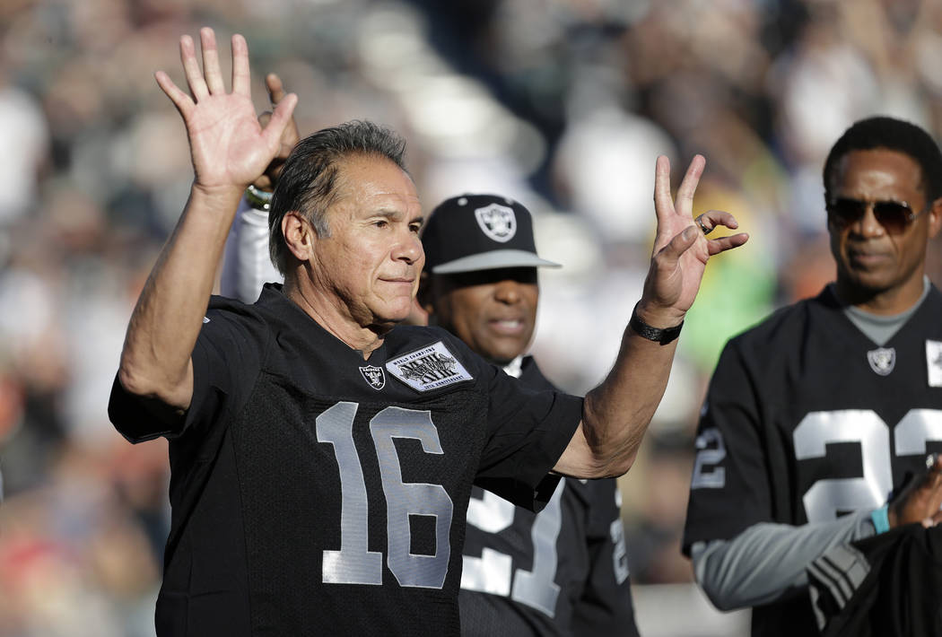 Former Oakland Raiders quarterback Jim Plunkett waves during a ceremony honoring the 1983 Los A ...