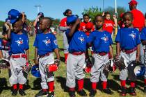 Members of the Blue Jays put their hats back on after the national anthem during the opening da ...