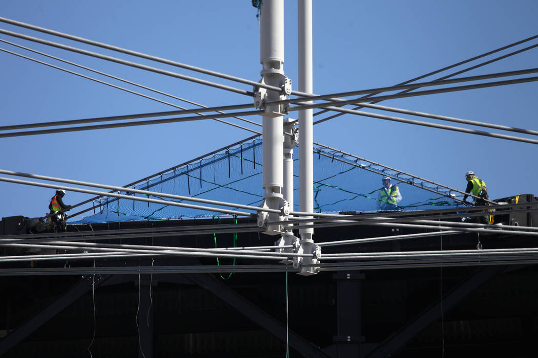 Netting is installed on top of the steel cable net system at the Raiders Allegiant Stadium in L ...