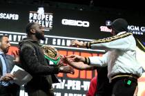 Tyson Fury, right, shoves Deontay Wilder during a press conference at the MGM Grand Garden Aren ...