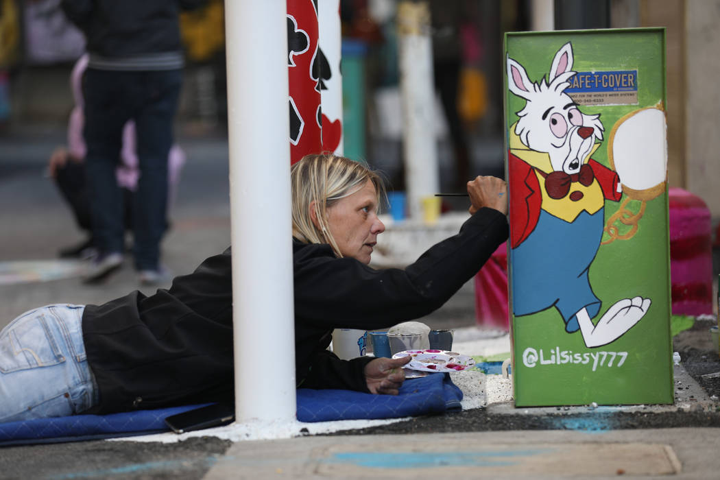 Local muralist Sissy Murphy paints during the grand opening dT-Alley in downtown Las Vegas on T ...